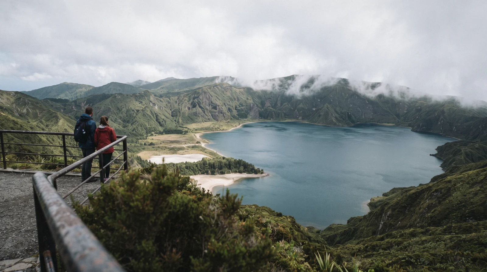 The pale crater bowl of Lagoa do Fogo under moving cloud, seen from the rim road