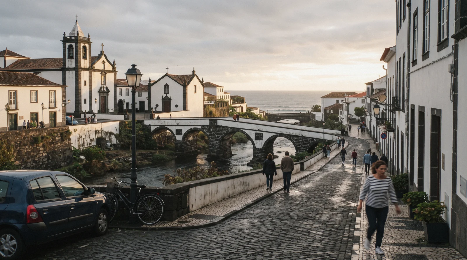 The historic centre of Ribeira Grande on São Miguel's north coast, with its churches and bridges over the river and the surf beyond the headland