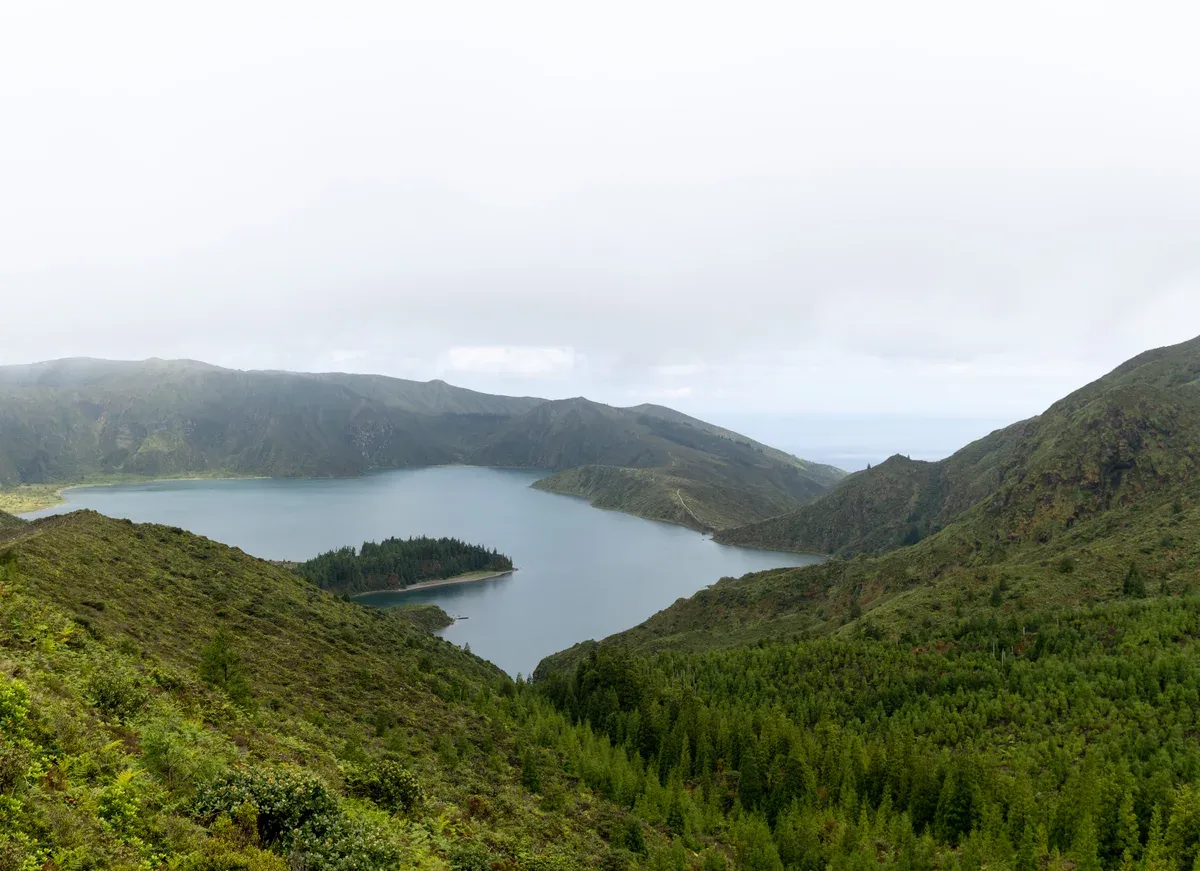 The Lagoa do Fogo crater lake seen from the Miradouro viewpoint below Pico da Barrosa on a bright day